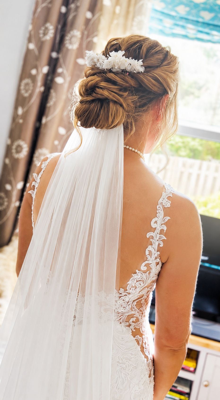 Bridal updo with veil and delicate floral pins