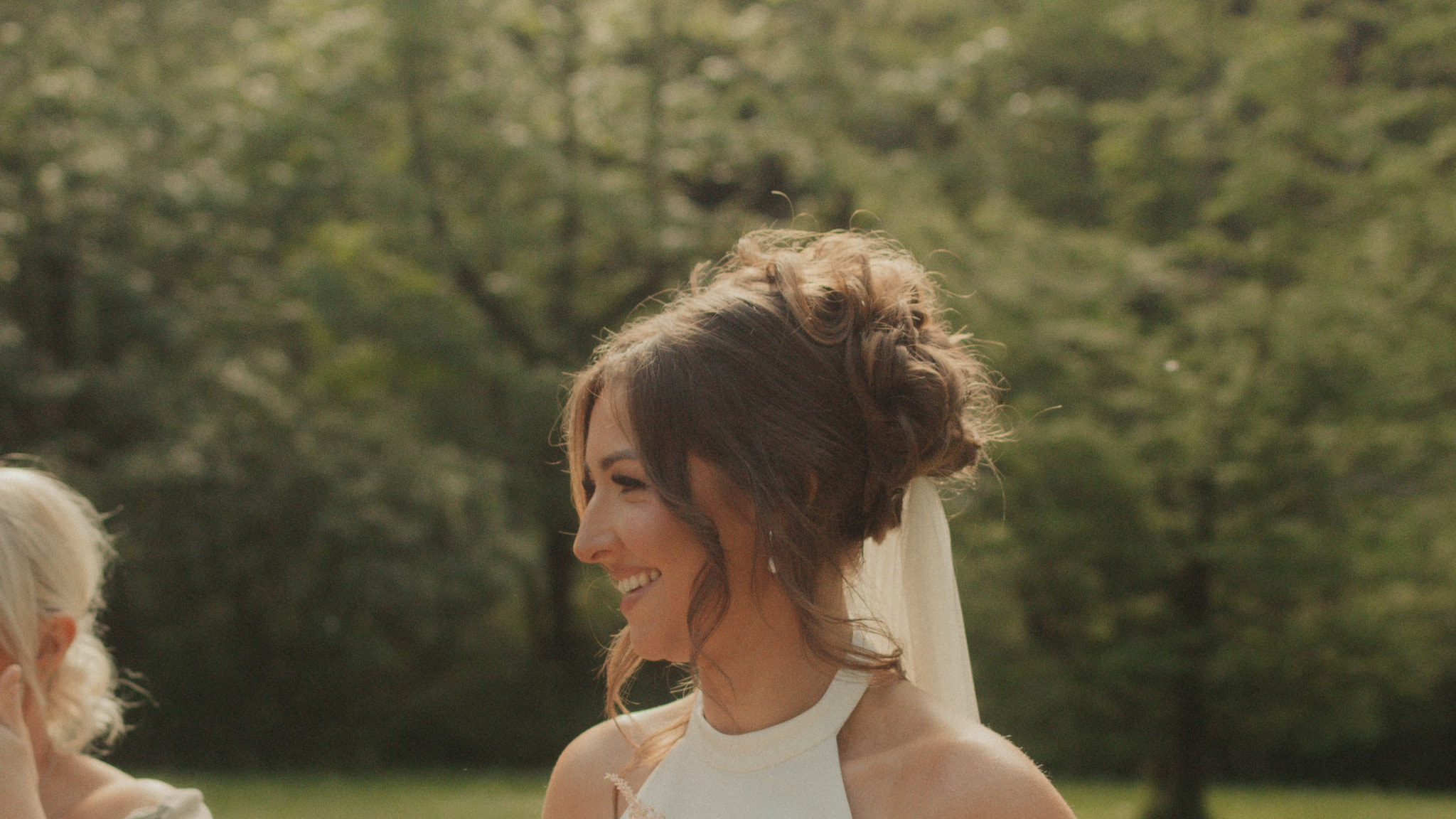 Bride with bouquet and champagne at an outdoor Cornwall wedding